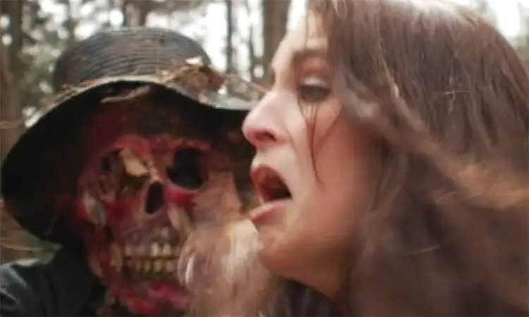 Skull faced figure menaces frightened girl in F0rest Primeval