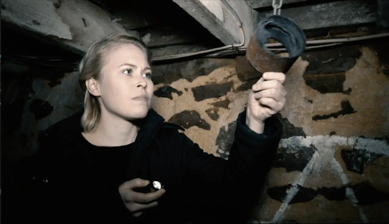 Girl examines Shackle in Hell House LLC: The Abaddon hotel