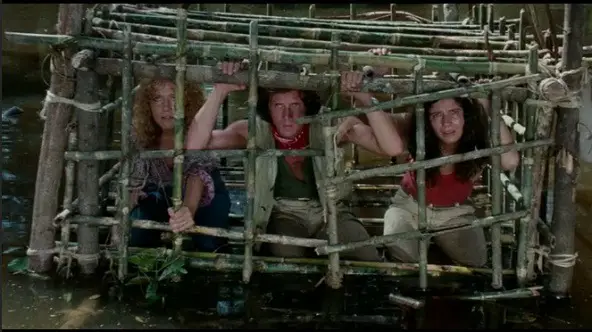 Cannibal Ferox still - people in wooden cage