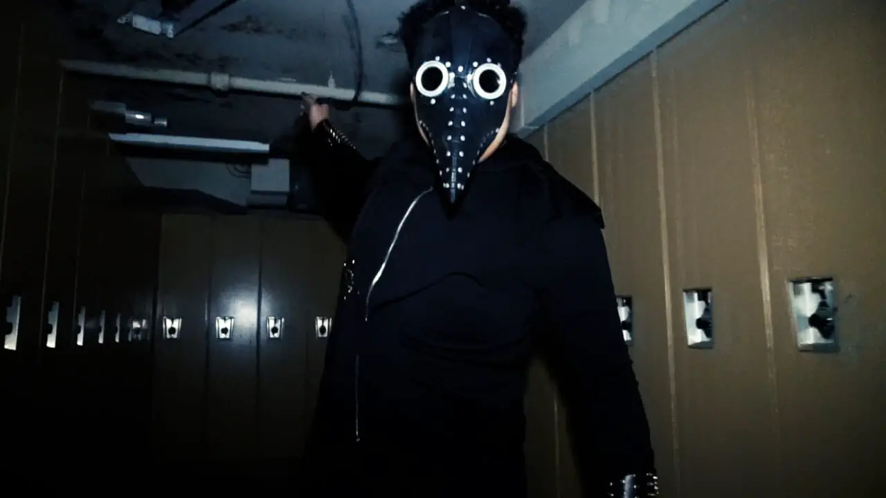 Man in gas mask in The Flock