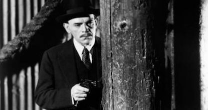 Boris as Mr. Wong holds gun