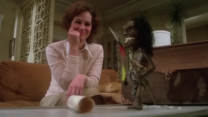 Karen Black looks at fetish doll