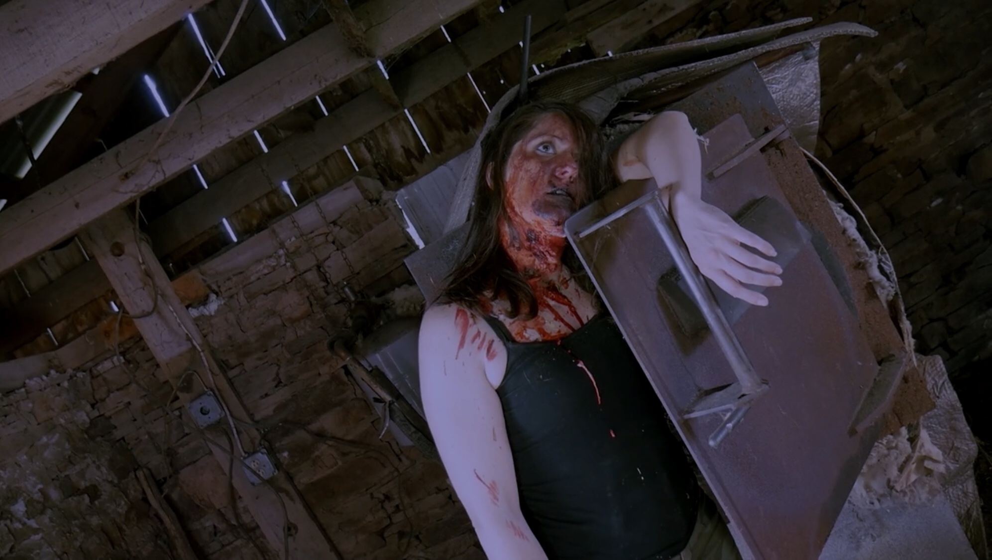 Victim slumps over metal door