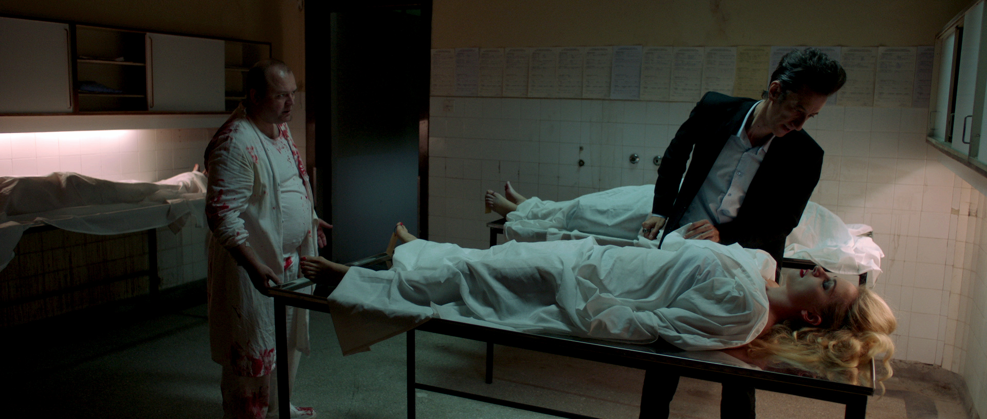 Guys look down on people on exam tables