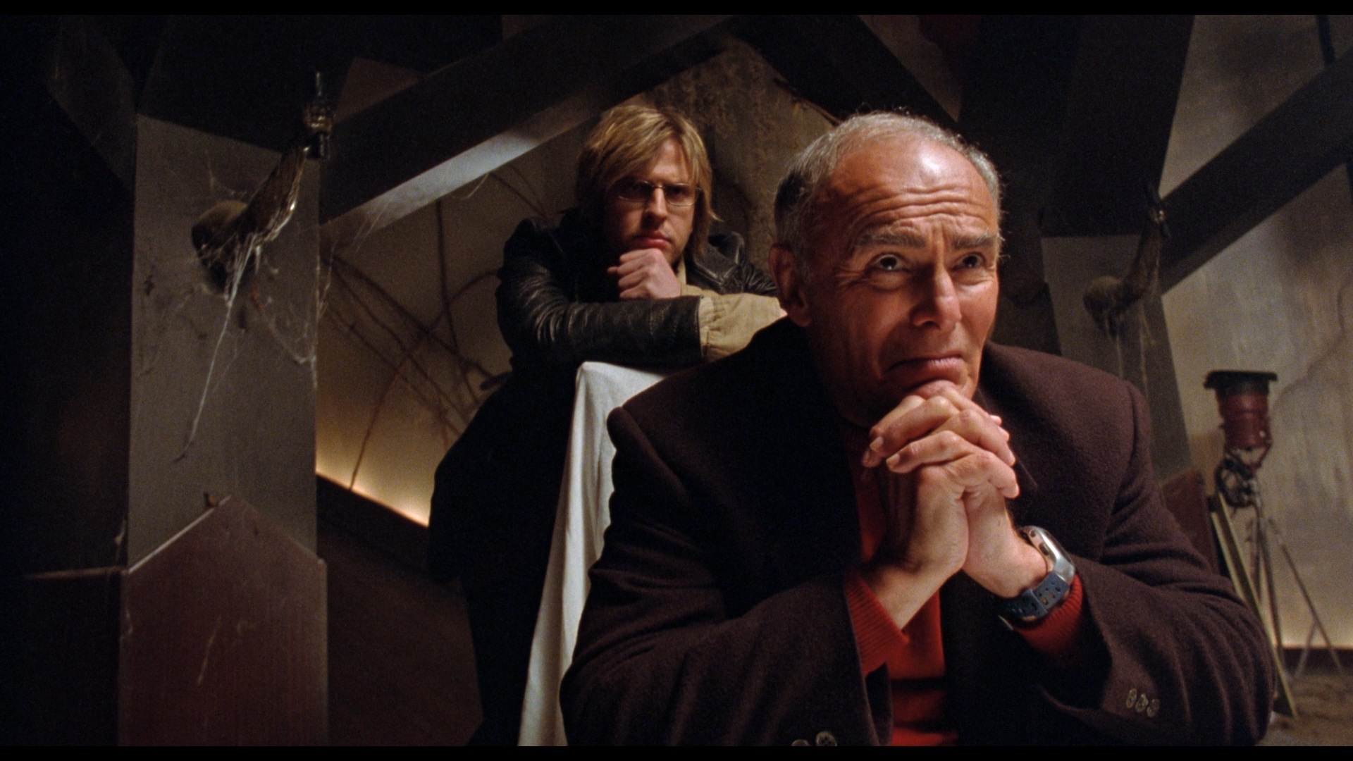 John saxon and another man look on with mock concern