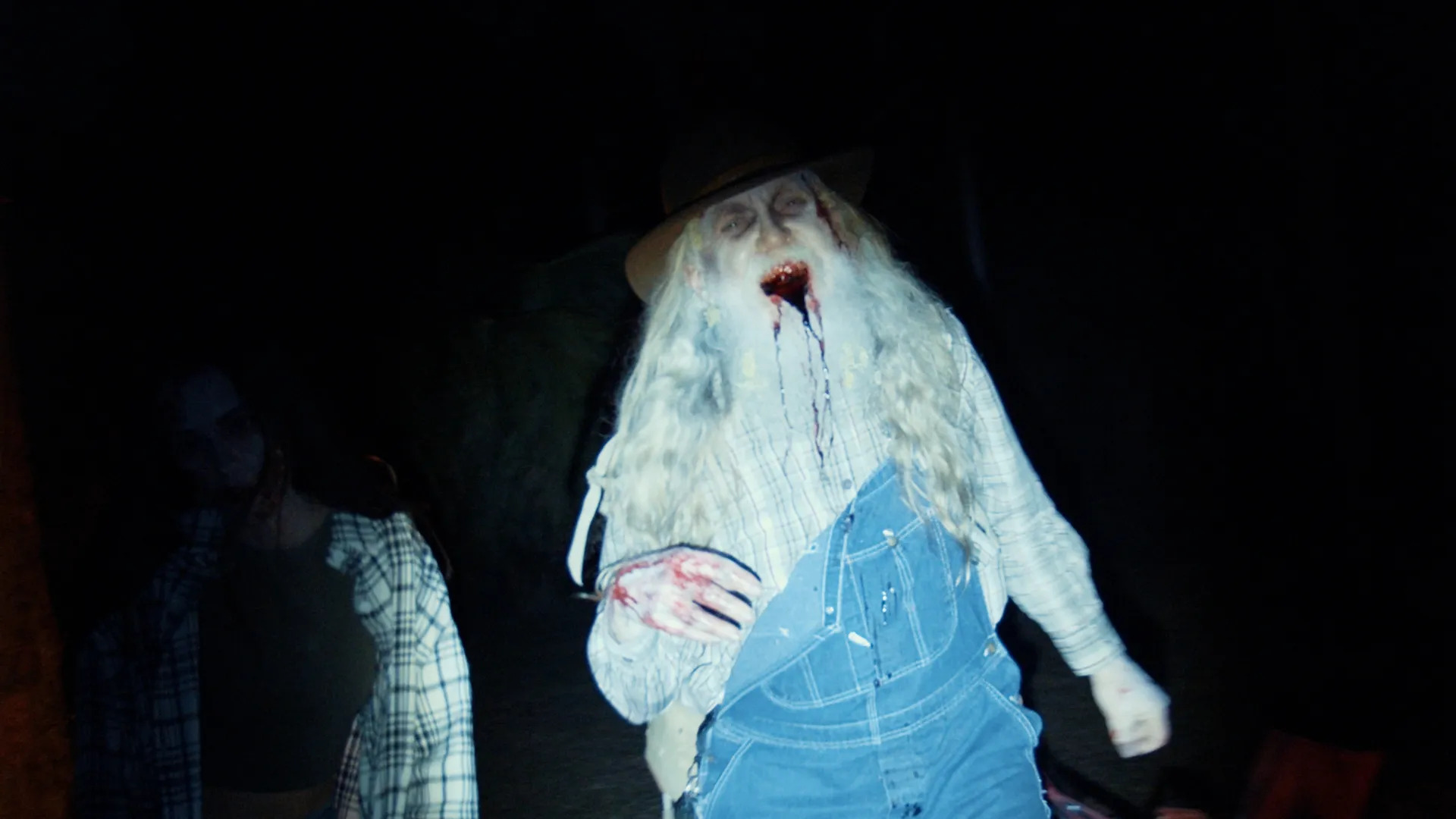 Guy in overalls with long beard bleeds