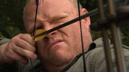 Man aims arrow in Dogman