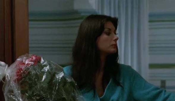 Woman looks to side with flowers in foreground