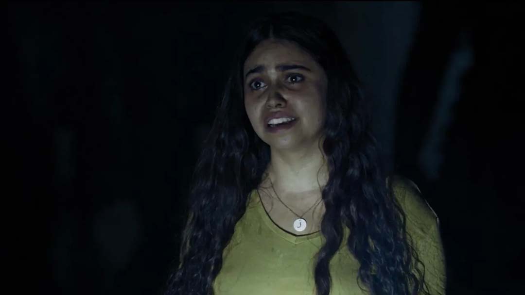 Frightened girl looks slightly left