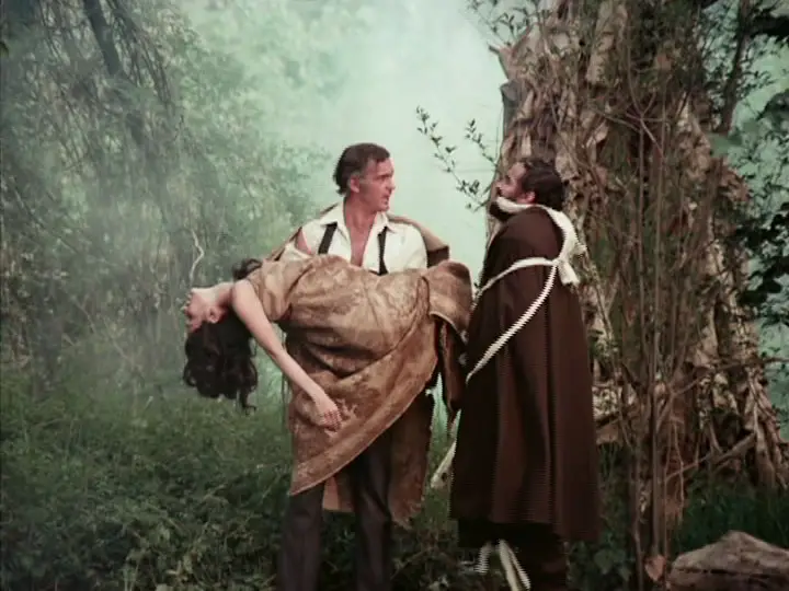 Man carries woman as he looks on bound man in cloak in Mansion of Madness