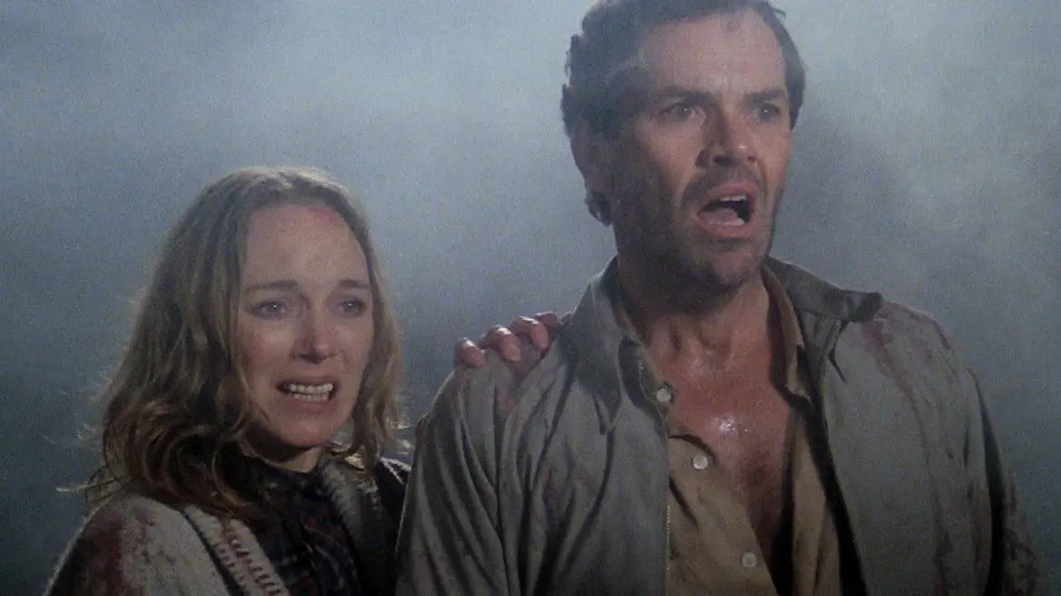 Couple in fog look off to scary sight in The Beyond