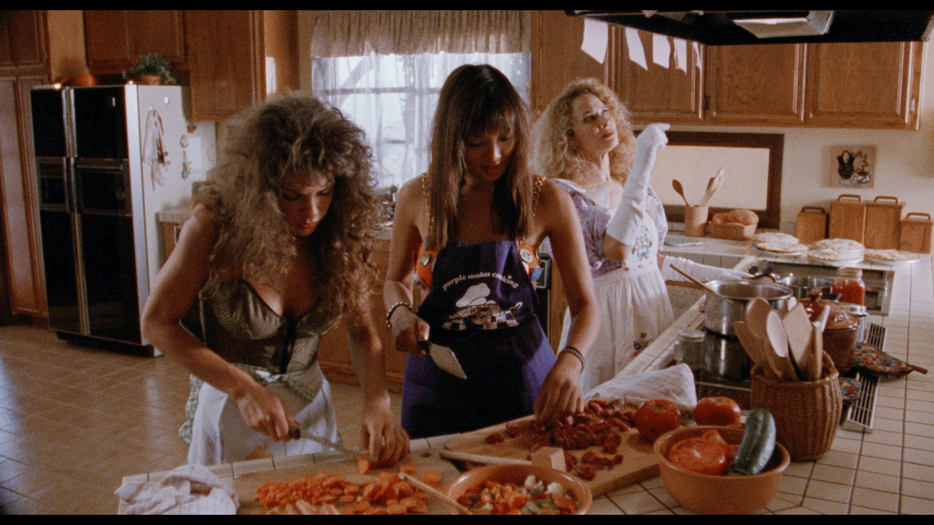 Women work in kitchen as Karen Black Pontificates