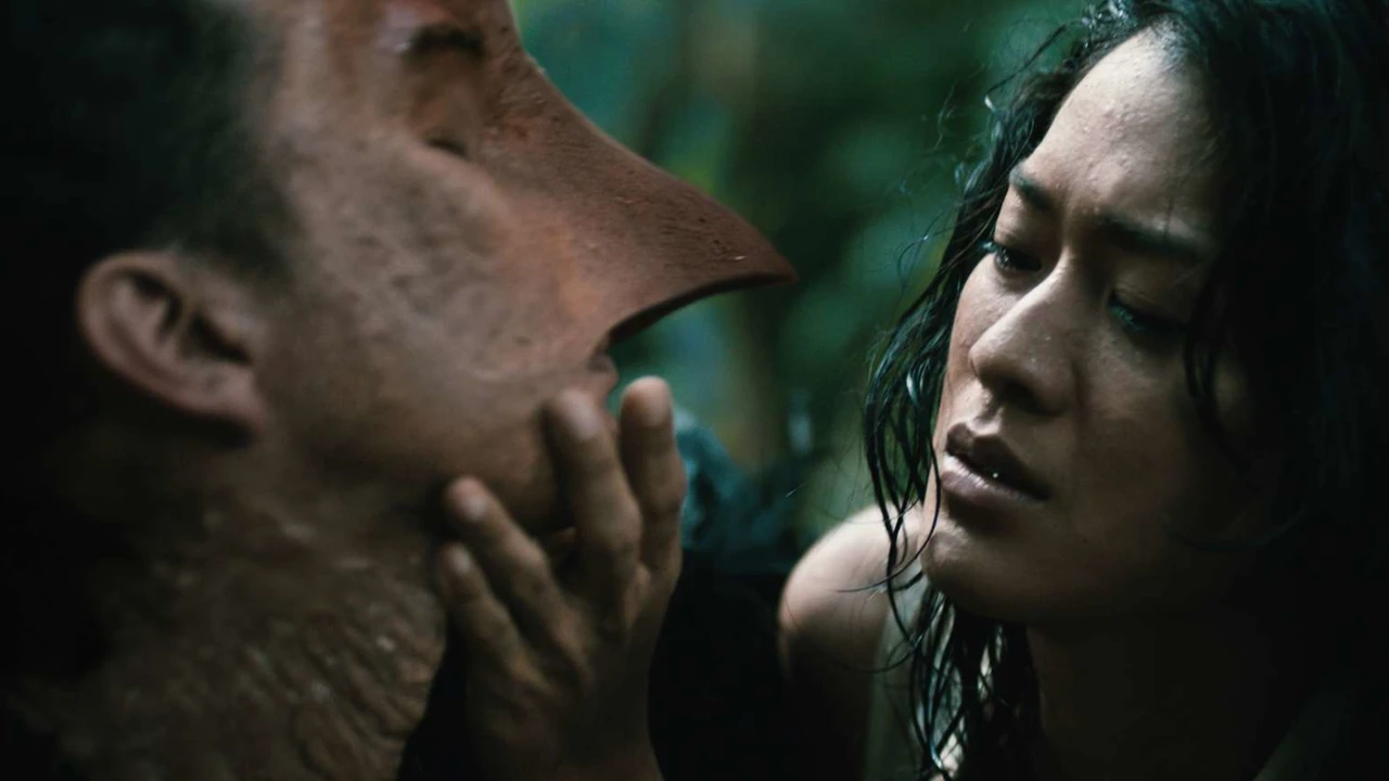 Woman looks at man growing a bird's beak