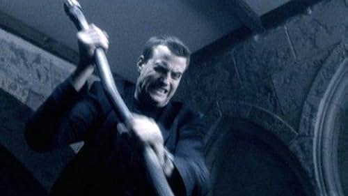 Man stabs downward with stick