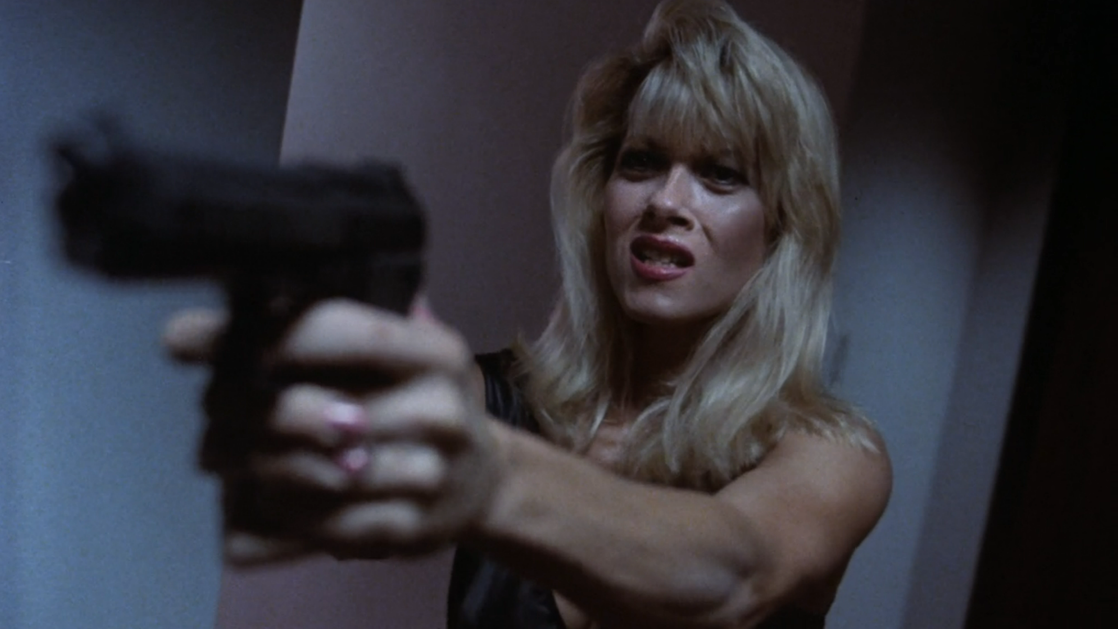 Woman aims gun off screen