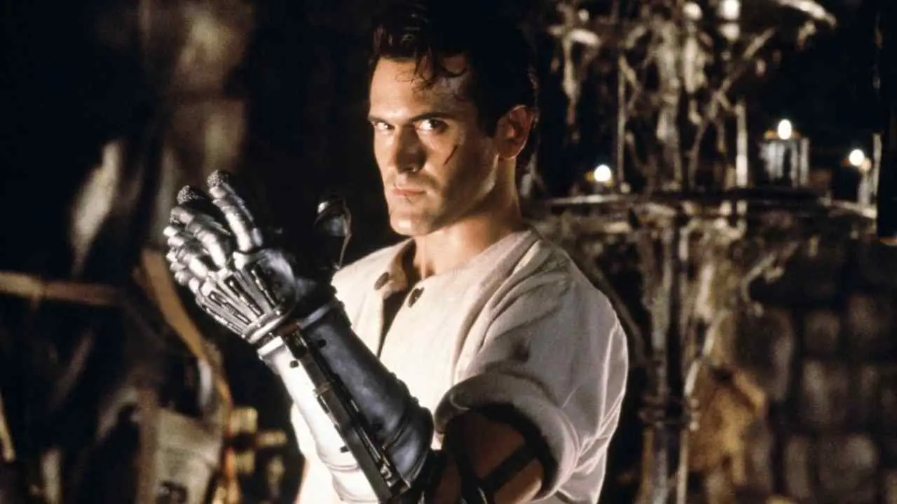 Ash (Bruce Campbell with a newly minted mechanical arm replacement/attachment in Sam Raimi's horror picture Army of Darkness.