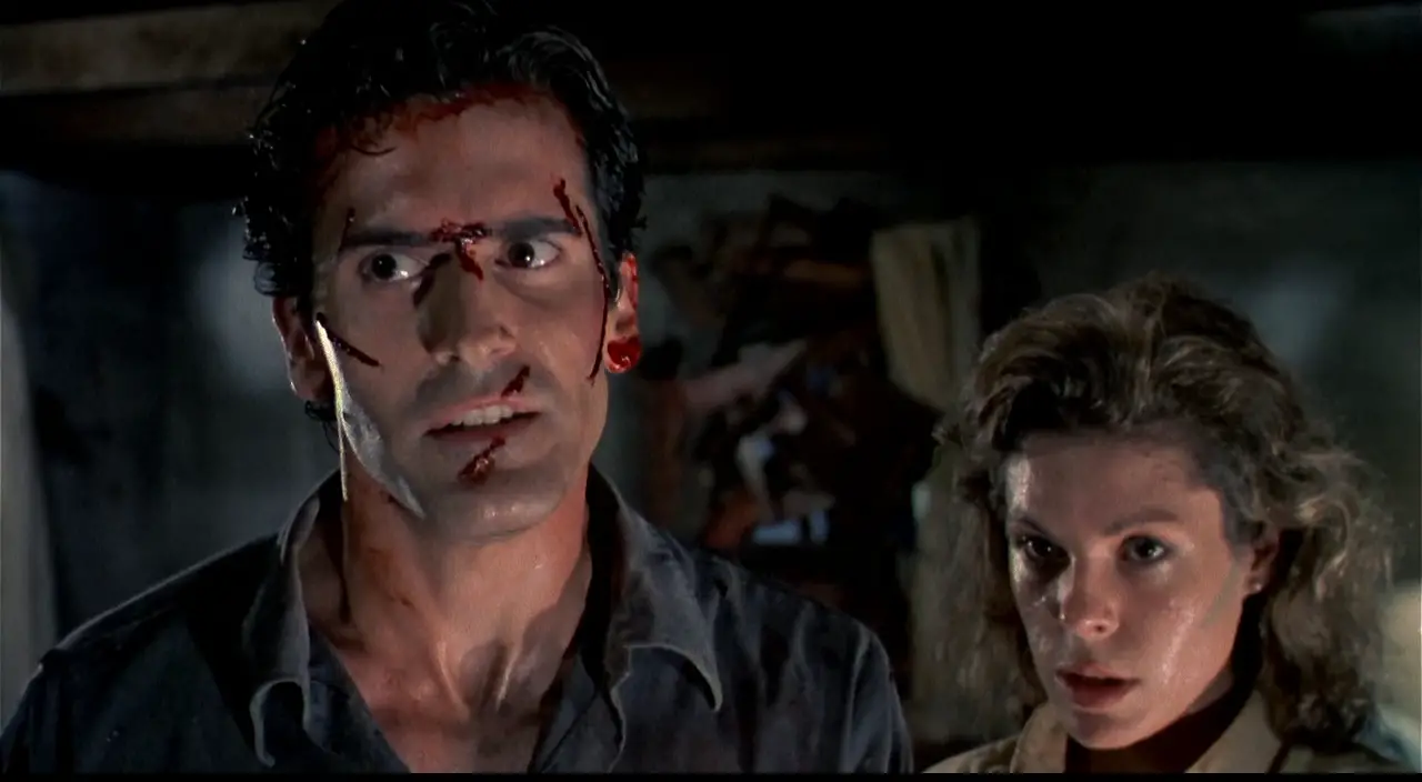 Ash (Bruce Campbell) and Annie (Sarah Berry) teaming up to fight evil in Sam Raimi's cult horror sequel Evil Dead II.