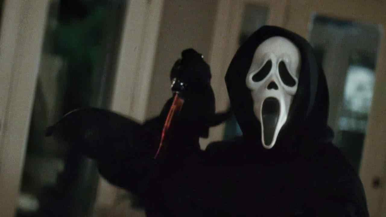 Ghostface, in Wes Craven's modern slasher classic Scream, with a bloody knife.