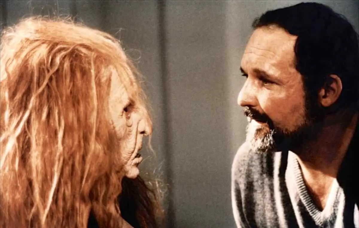 Jonathan Stryker (John Vernon) and one of his aspiring actresses in a hag mask.