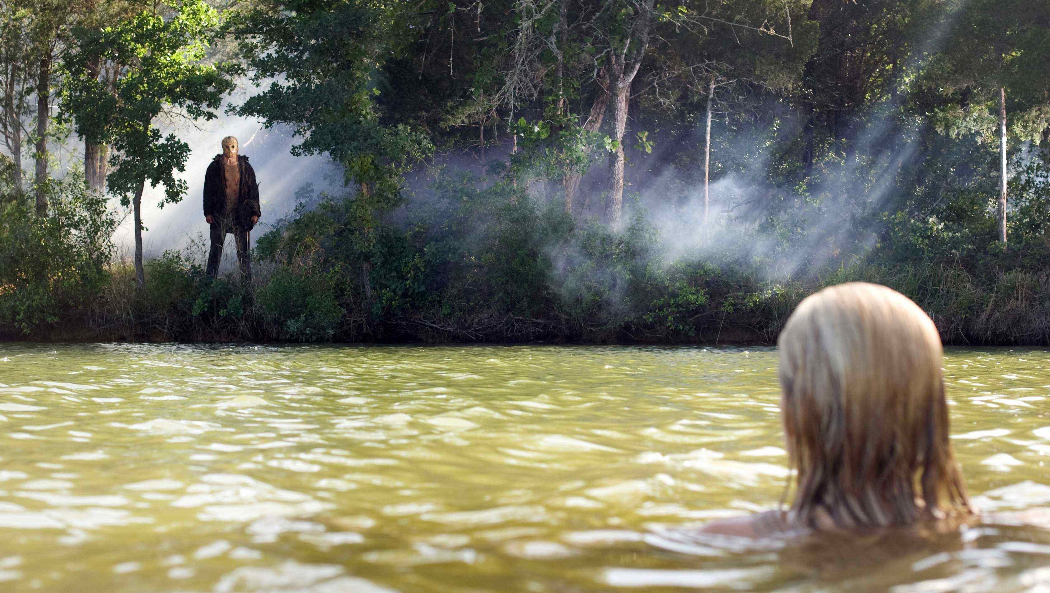 The infamous Jason Voorhees looks over his victim in the hit horror Friday the 13th.