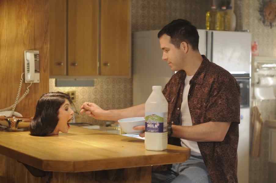 The Voices -- Ryan Reynolds feeds his severed head as Jerry in The Voices.