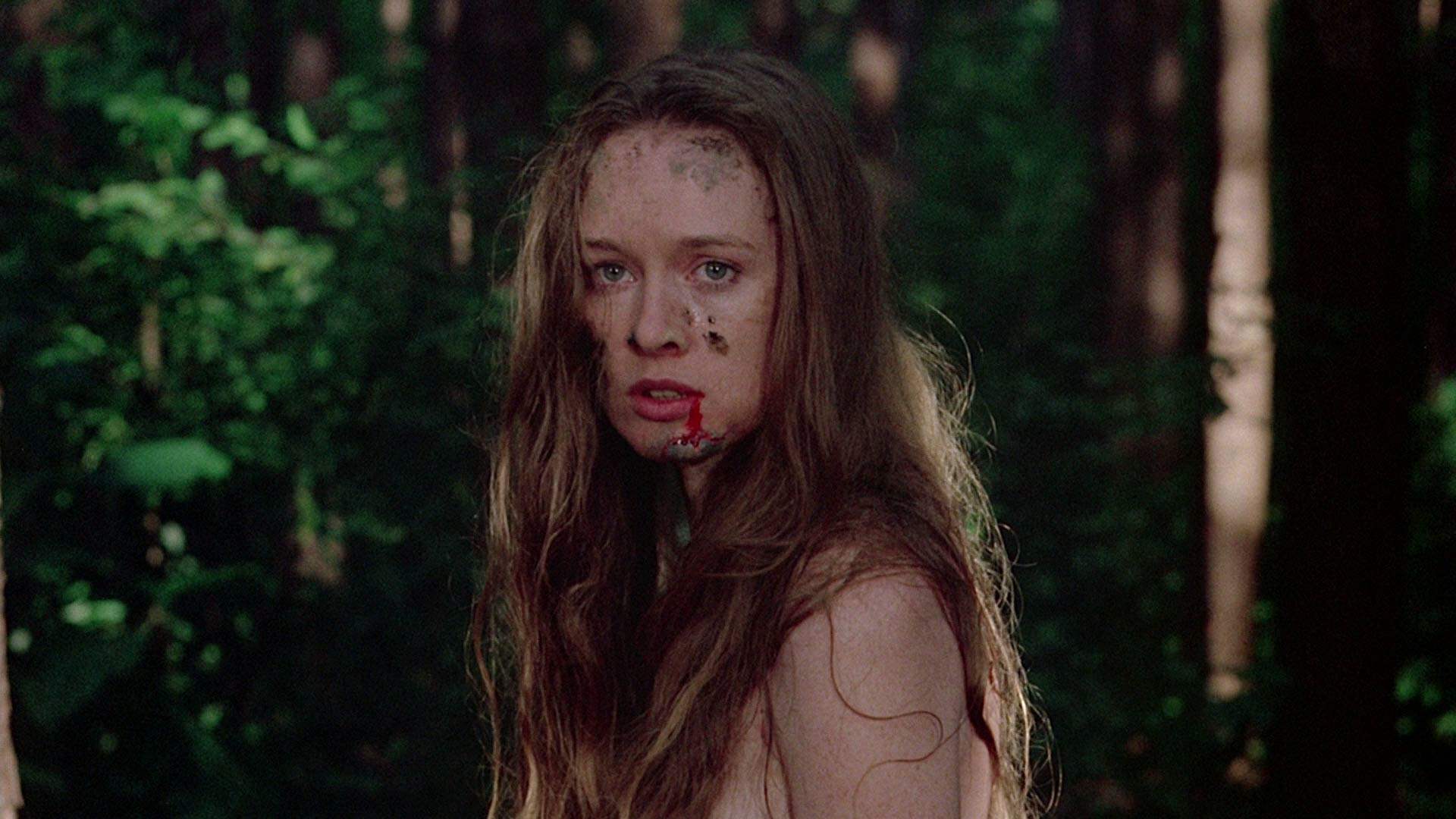A dirty and bloody Jennifer wanders the woods after being assaulted in I Spit on Your Grave.