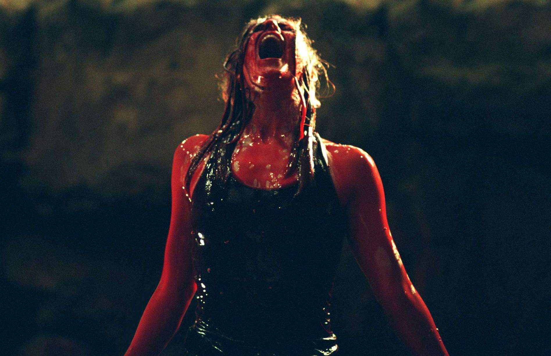 Sarah emerges from the lake of blood after killing several monsters in The Descent