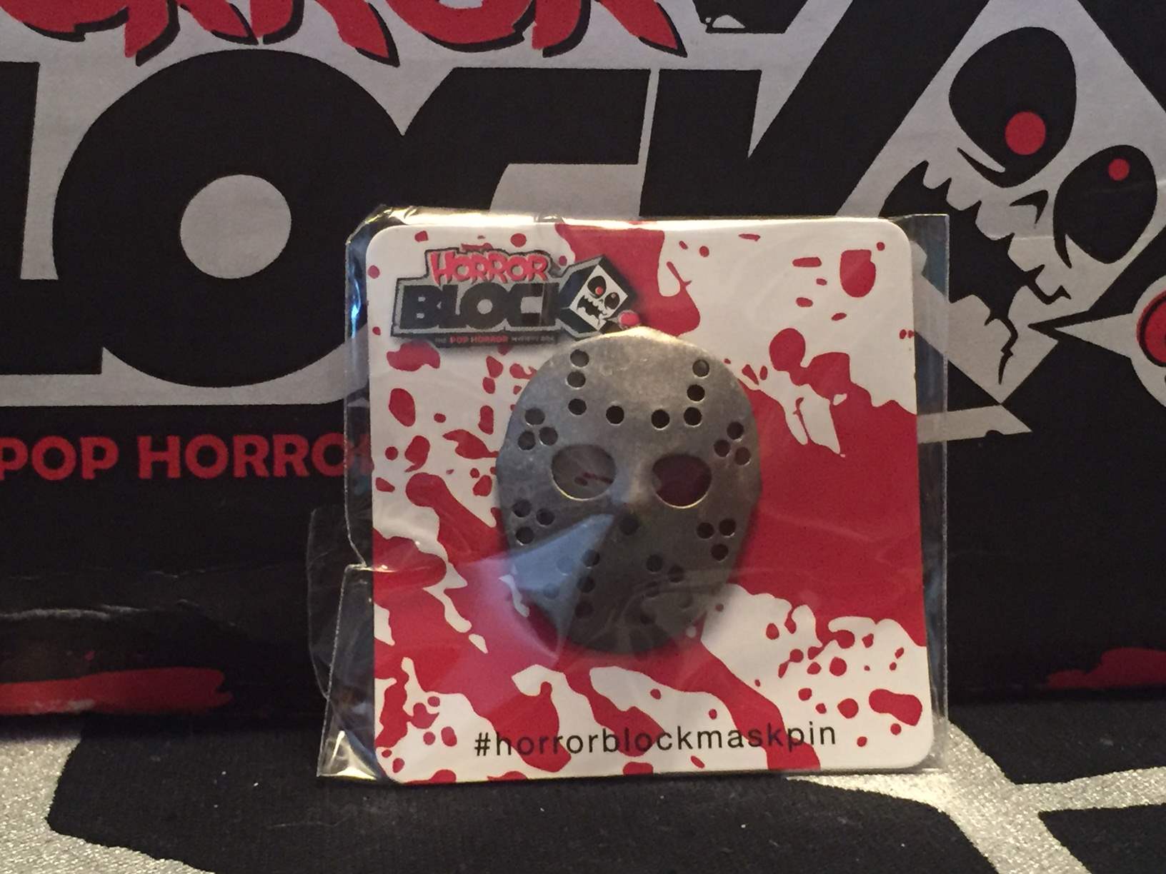 A silver hockey mask pin in the May 2016 Horror Block