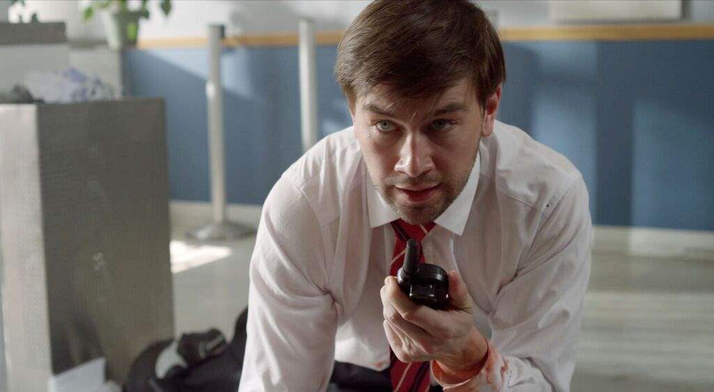 Torrance Coombs in The Last Heist walkie talkie