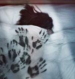 The Darkness poster image of black handprints on a bed