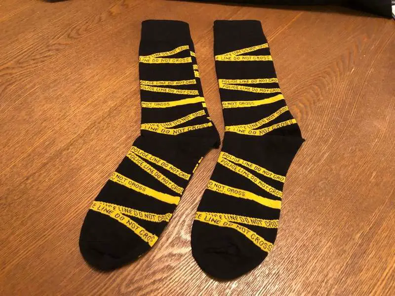 Crime scene tape socks in the December 2018 Creepy Crate