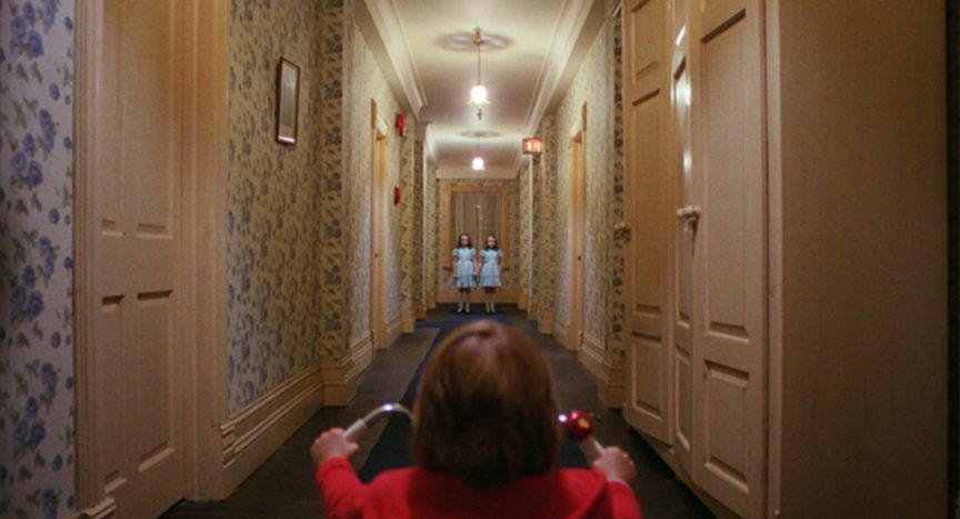 Danny and twin girls in hallway in Kubrick's The Shining