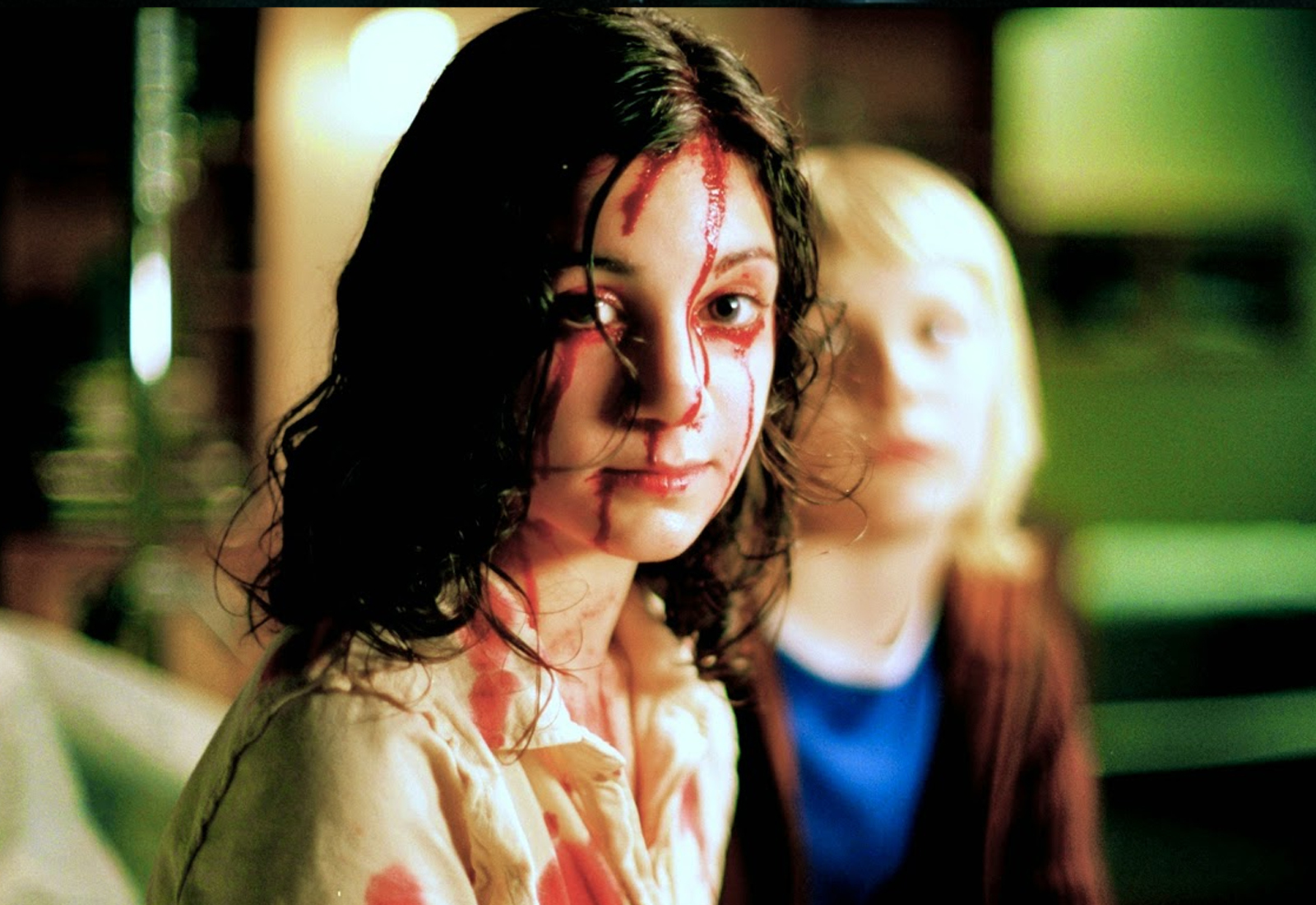 Eli with blood all over her, and Oskar in the background