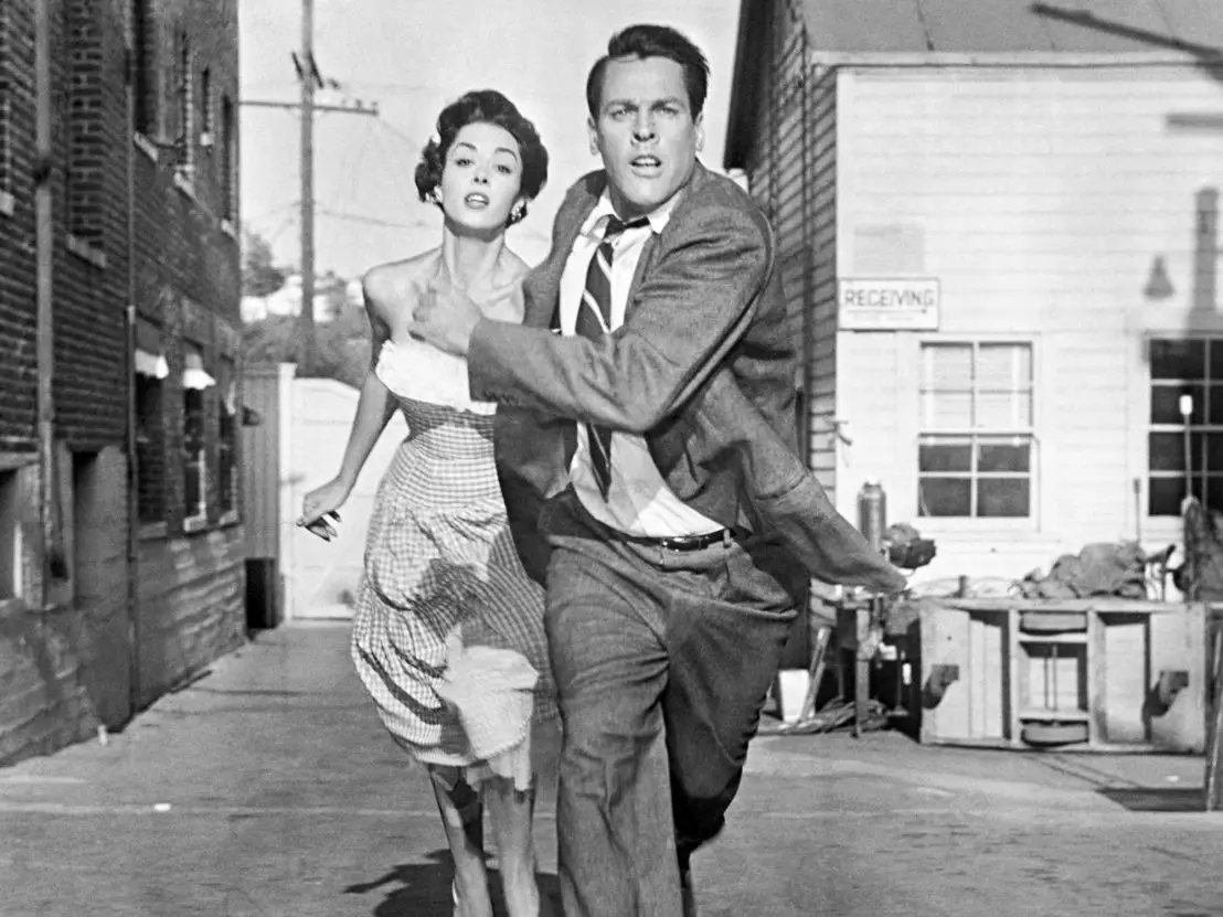 Miles and Becky running down a street