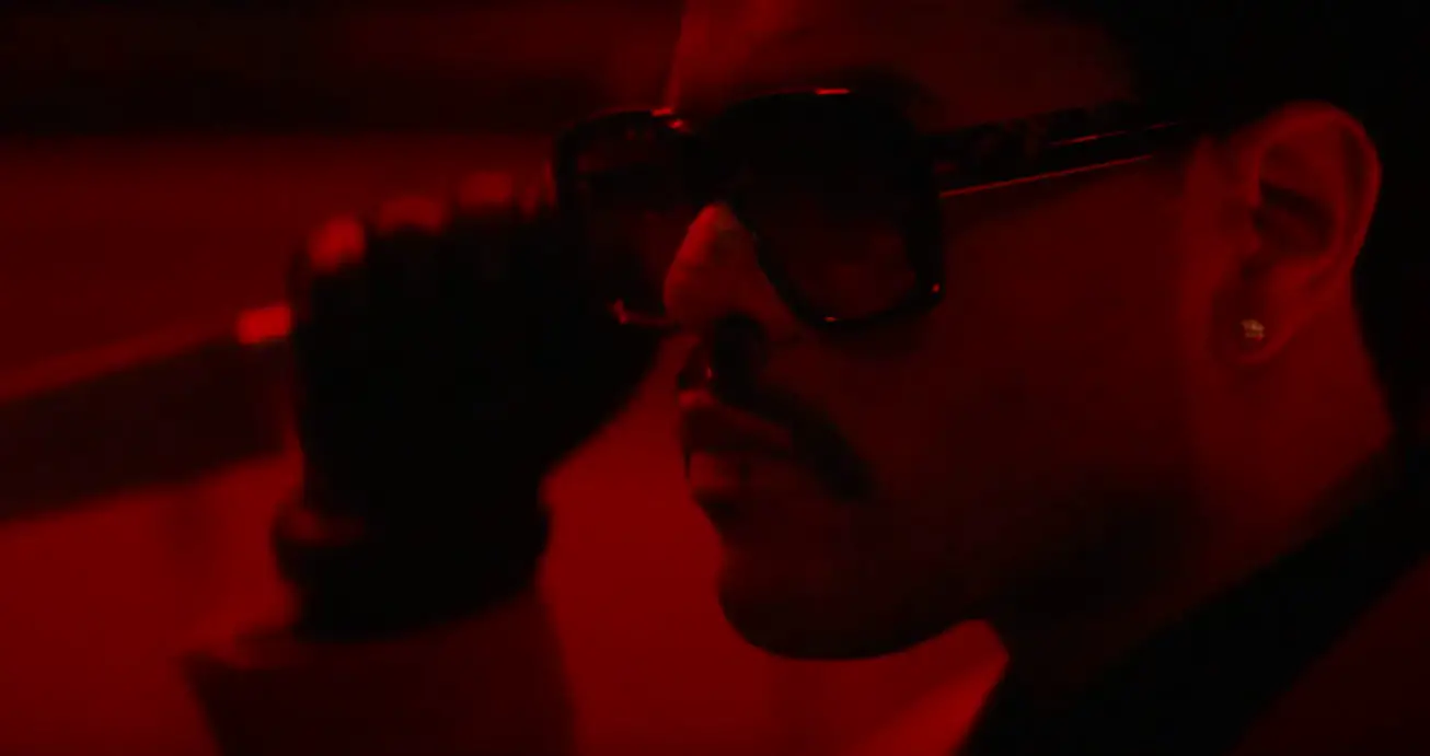 The Weeknd holding a knife during "Save Your Tears," an 80s slasher horror-inspired music video.