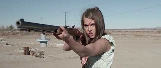 A girl aims a shotgun in the tribe